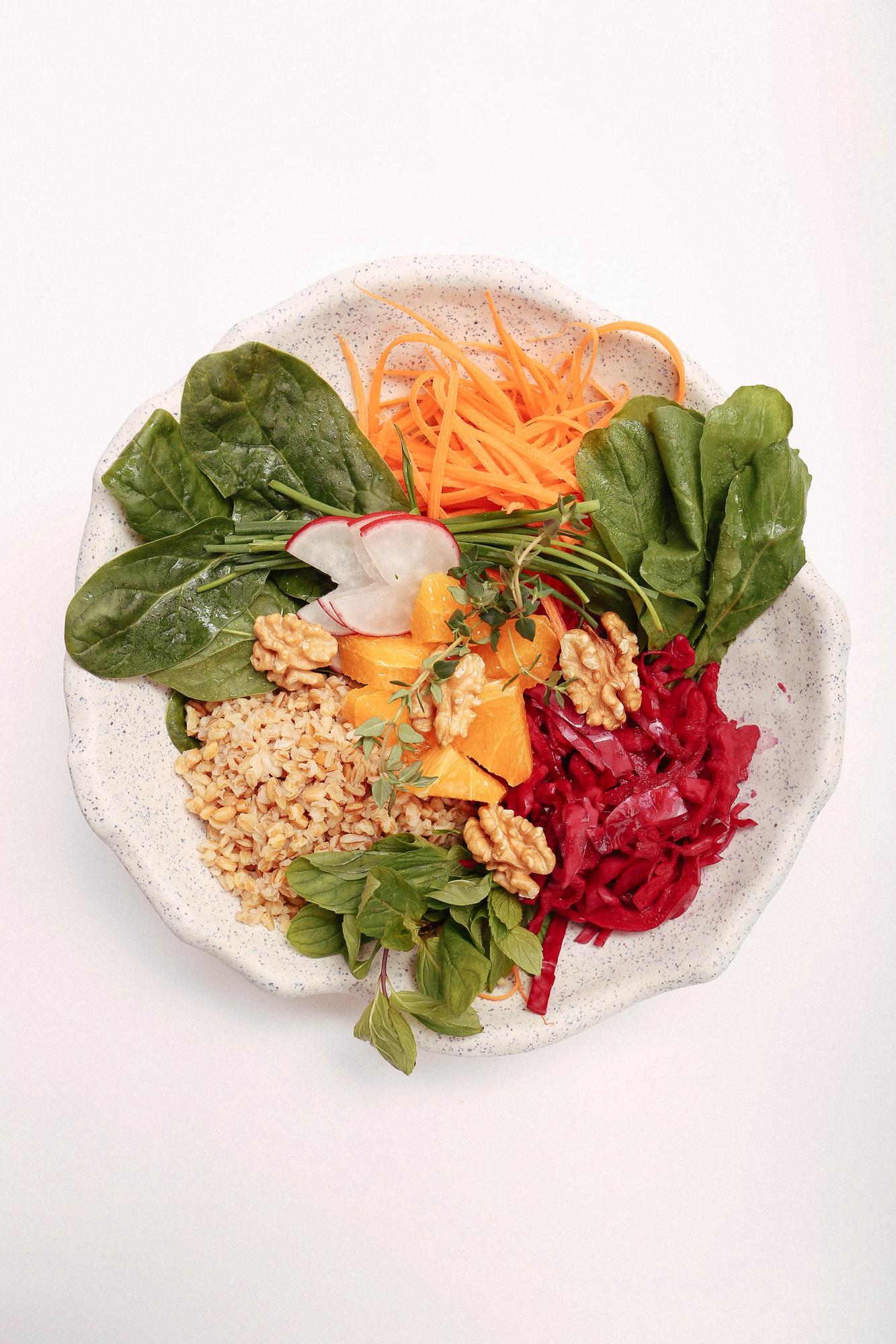 colorful buddha bowl with grains and greens